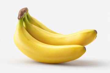A bunch of ripe yellow bananas stacked on top of each other against a plain white background studio shot