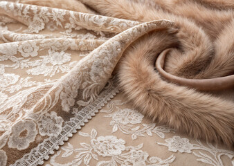shows a luxurious textile piece featuring a floral lace pattern and a plush, furry fabric. The combination of textures and colors creates a rich and sophisticated appearance.