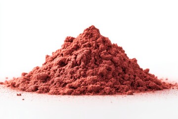 A mound of pinkish red powder against a stark white background in a studio setting close up view