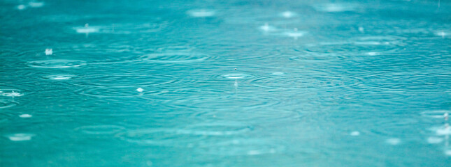 A body of water with raindrops falling on it