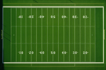 American football field with green grass and white lines on a sports ground