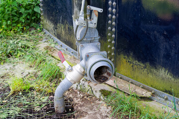 Rural landscape at farm with close-up of pipe of liquid manure tank at Swiss city of Zürich. Photo taken May 16th, 2025, Zurich Schwamendingen, Switzerland.