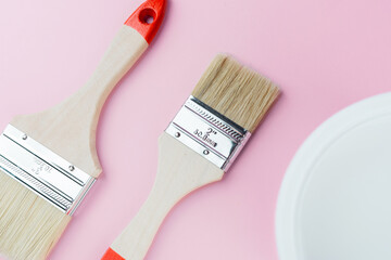 Closeup of paintbrushes on pink background for painting tools and craftsmanship concept