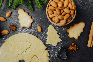 Christmas almond cookies and dough with fir branches and spices for holiday food styling concept