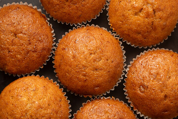 Banana cake in paper cup on black background.