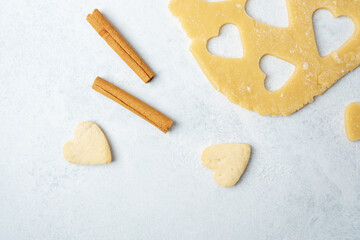 Heart shaped cookies with cinnamon and raw dough for baking or valentines day concept
