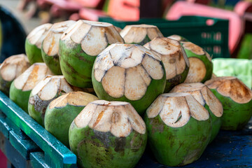 Fresh coconuts prepared for drinking, displayed in a market in Tortuguero, Costa Rica, a popular tourist destination in the Caribbean