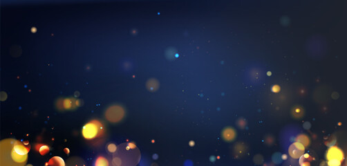 Festive bokeh lights on dark blue background - gold yellow orbs floating with bright sparkles. Blurred glowing circles and shimmering dots for celebration wallpaper or holiday party backdrop design.