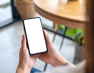 Over shoulder close up view of female hand holding smartphone with mock-up screen