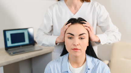 Doctor diagnoses the structure of the hair. Consultation with a trichologist