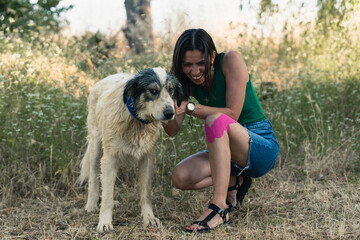 Funny moment between dog and owner while brushing it in a field