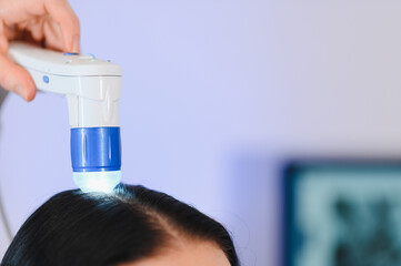 Doctor diagnoses the structure of the hair. Consultation with a trichologist