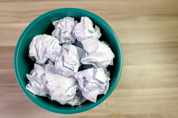 crumpled paper ball in trash can, paper waste, trash bin in office with crumple paper ball, work hard ideas concept