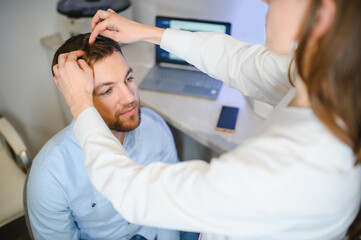 Trichoscope examination of hair, scalp and hair follicles of a young man. Copy space banner
