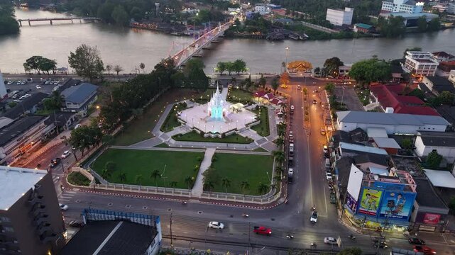 Surat Thani,Thailand-28 Jan 2025:Timelapse of Surat Thani City Pillar Shrine and skyline along the Tapi River in Thailand, showing day-to-night transition.
