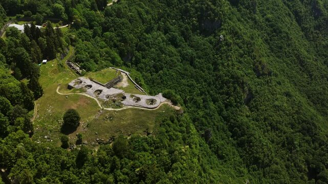Aerial showcasing Forte Corbin amid dense greenery, emphasizing history and nature.
