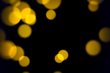 Glowing yellow soft bokeh lights on dark background for abstract elegant party ambiance romantic decoration or vintage style visuals