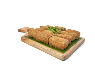 Tahu sumedang or Indonesian food made from deep-fried tofu on chopping board Isolated on white...