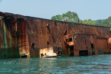 Wide shot of abandoned ship at the ocean of Pantai Pasir Putih or White Sand Beach in Pantai Barat...