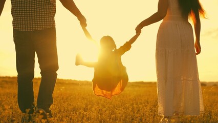 happy family park. little kid daughter runs across meadow sunset. mother father kid child travel...