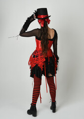 full length portrait burlesque circus performer, female model in halloween jester clown costume...