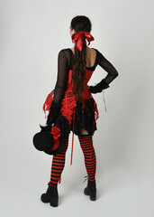 full length portrait burlesque circus performer, female model in halloween jester clown costume...