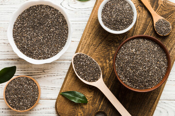 Chia seeds in bowl and spoon on colored background. Healthy Salvia hispanica in small bowl. Healthy...