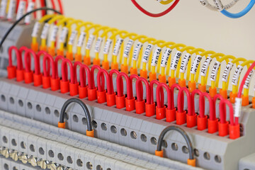 Marking electrical wiring wires with thermally printed nylon tape. 