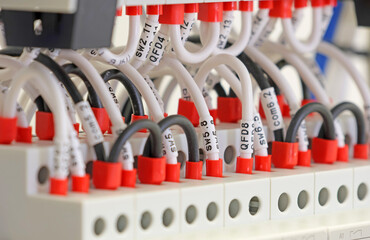 Marking electrical wiring wires with thermally printed nylon tape. 