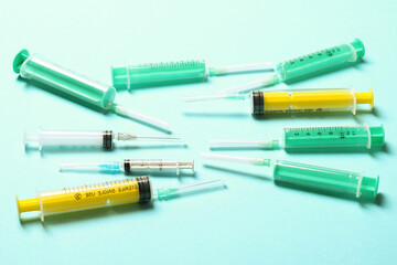 Top view of different syringes at blue background. Medical injection concept with copy space