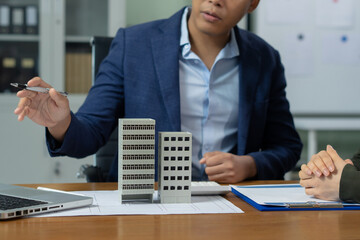 Real estate broker agent presenting and consult to customer to decision making sign insurance form...