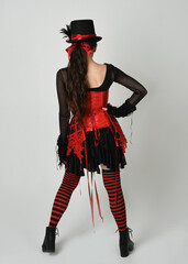full length portrait burlesque circus performer, female model in halloween jester clown costume...
