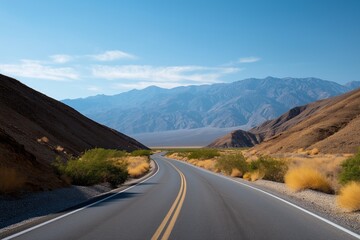 Scenic desert road with mountain views under clear blue sky