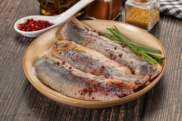 Salted marinated herring fillet with spices