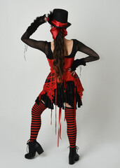 full length portrait burlesque circus performer, female model in halloween jester clown costume...