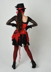 full length portrait burlesque circus performer, female model in halloween jester clown costume...