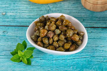 Pickled canned capers in the bowl