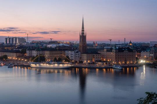 Scenic view of Stockholm's Riddarholmen at sunset with reflections on Lake Malaren