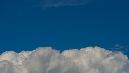 White cloud against a blue sky background.