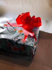 Gift wrapped beautifully for a special occasion with red ribbon on top
