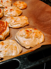 Freshly baked flatbreads with golden crust on parchment paper in a warm kitchen