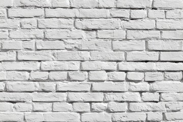 Obraz premium A textured image of a whitewashed brick wall, showing variations in brick size and slight discoloration, creating a rustic aesthetic