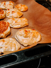 Freshly baked pastries on parchment paper cooling in a kitchen