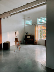 Spacious art studio with natural light and musical ambiance during afternoon hours