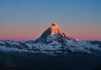 Sunset glow on majestic mountain peak in winter landscape