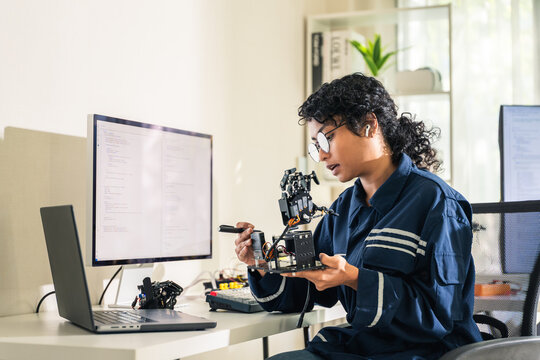 Female Engineer Developing Robotic Arm Prototype at Home Office Laboratory.