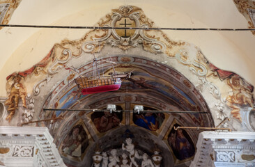 Baroque interior of a church in Monterosso al Mare with rich stucco and symbolic decoration and a...
