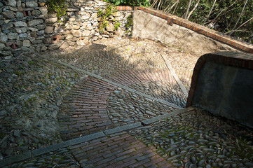 Monterosso al Mare, Italy - An ancient cobblestone path with a circular pattern of stones and...