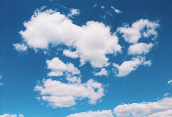 Fluffy white clouds drift across a vibrant blue sky, creating a serene natural backdrop.