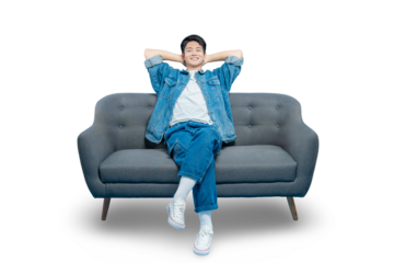 A happy young man leans back on the couch with his hands behind his head, enjoying a moment of pure relaxation,PNG